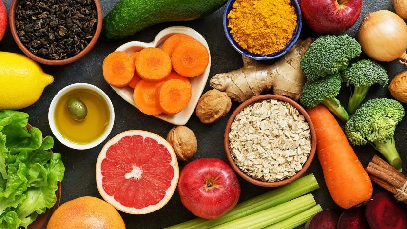 Warm overhead photo of bowls with varied plant foods